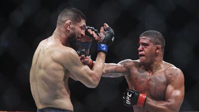 Gilbert Burns punches Khamzat Chimaev during their welterweight bout at UFC 273. Getty