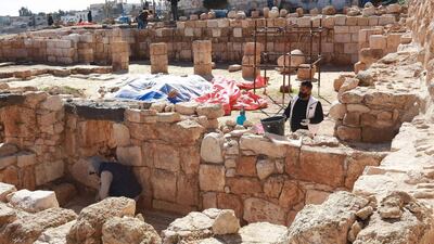 Workers restore a stone wall at the Byzantine church complex at Rihab, Jordan, which dates back almost 1,500 years. AFP