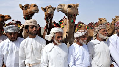 Men watch other tribal members sing poetry during a tribal celebration hosted by the Al Badi tribe in Saham, Oman in February 2017. Jeff Topping for The National