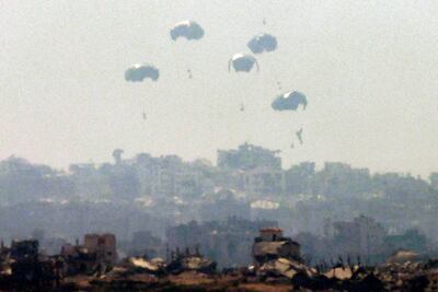 Humanitarian aid is dropped on the Gaza Strip as pictured from the border in southern Israel on July 27, 2025. AFP