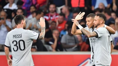 Paris Saint-Germain's French forward Kylian Mbappe celebrates with Neymar and Lionel Messi. AFP