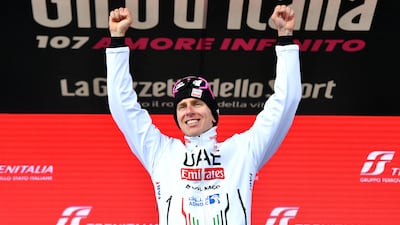 UAE Team Emirates' Tadej Pogacar celebrates on the podium after winning Stage 15. Reuters