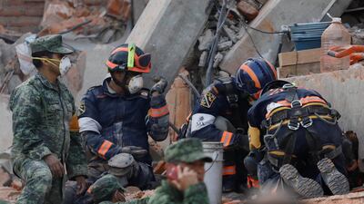 Rescue workers search for students through the rubble after an earthquake at Enrique Rebsamen school in Mexico City. Edgard Garrido / Reuters