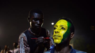 A Sudanese protester gets his face painted during their sit-in outside the army headquarters in Khartoum on May 9, 2019. AFP