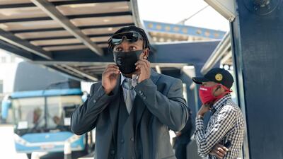 Chamunorwa Chibhabha adjusts his face mask at Robert Mugabe International Airport in Harare. Zimbabwe are touring Pakistan for a limited overs series. AFP