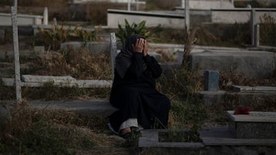 A Palestinian visits graves of deceased relatives during the first day of Eid al-Fitr holiday in Gaza City. AP