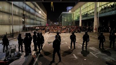 Protesters face police officers as they demonstrate at the airport, after a verdict in a trial over a banned independence referendum, in Barcelona, Spain. Reuters