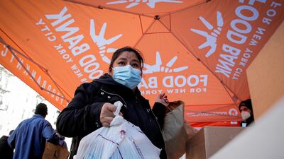 A woman takes a holiday box of food from the Food Bank For New York City ahead of the Thanksgiving holiday in Harlem. Reuters