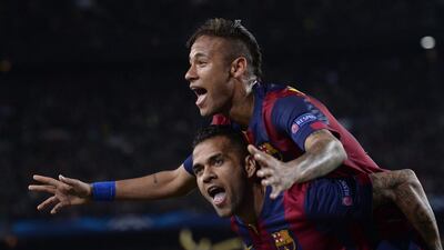 Barcelona's Neymar celebrates on the shoulders of teammate Dani Alves, after scoring his second goal during the Champions League quarterfinal second leg soccer match between FC Barcelona and Paris Saint Germain at the Camp Nou Stadium in Barcelona, Spain, Tuesday, April 21, 2015. (AP Photo/Manu Fernandez)