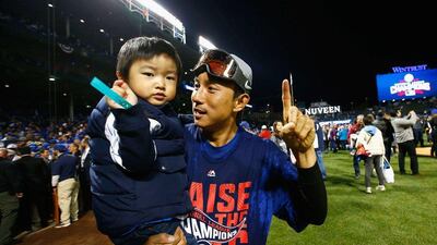 Munenori Kawasaki of the Chicago Cubs celebrates with his son after defeating the Los Angeles Dodgers 5-0 in Game 6 of the National League Championship Series. Jamie Squire/Getty Images