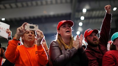 Supporters cheer as Donald Trump attends a campaign rally at Pensacola International Airport in Florida. Reuters
