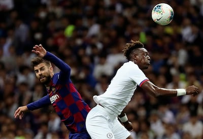 Chelsea's Tammy Abraham, right, gets the better of Barcelona's Gerard Pique. AP Photo