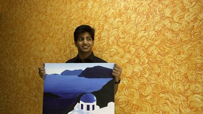 Keenan D’Abreo, 16, with one of his paintings. His Paint for Change art exhibitions and sales, organised with other teenage artists, raise money for centres catering for special-needs children. Jaime Puebla / The National