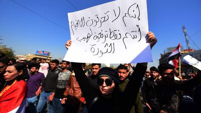 An Iraqi university student holds a placard reading in Arabic 'you do not burn tents, but you are fuelling revolution' during a protest in central Baghdad, Iraq. EPA