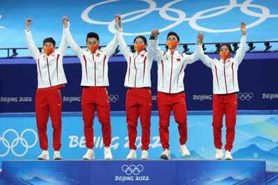 Gold medallists Team China pose during the mixed team relay final flower ceremony at the Capital Indoor Stadium. Getty
