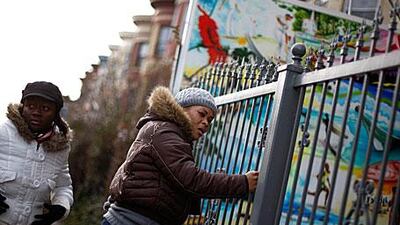 Marie Hilaire, right, a Haitian living in New York, learns her father-in-law was killed in the earthquake as her niece, Marie Etienne, stands by.