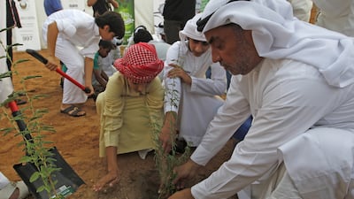 Orphans plant saplings of Ghaf trees at the heritage village in Al Shindagha to commemorate Zayed Humanitarian Day. Jeffrey E Biteng / The National