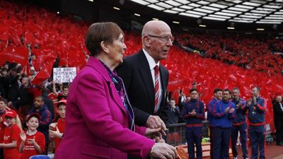 Sir Bobby Charlton and wife Norma walk out onto the pitch as the newly renamed South Stand "Sir Bobby Charlton stand" in unveiled to commemorate the 60 year anniversary of his debut for Manchester United. Reuters