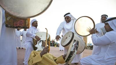 A group of performers from Al Ain playing their instruments at the Zayed Heritage Festival near the Al Wathba camel race track near Abu Dhabi. Silvia Razgova / The National