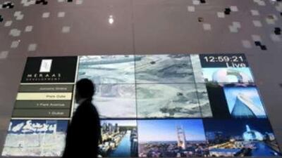 A man walks past a projection of Meraas Developement at Cityscape Dubai at the Dubai International Exhibition Center. The company is reviewing one of its showpiece developments, Jumeriah Gardens.