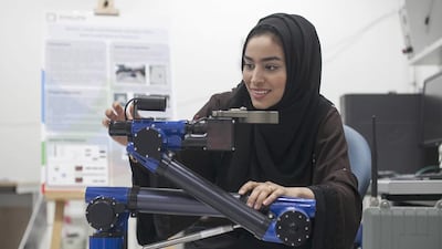 Maha Al Ajmi demonstrates her robotic project for use in retrieving samples from search-and-rescue scenarios. Mona Al Marzooqi / The National