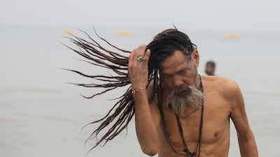 A monk takes a holy dip on the second day of Ganga Sagar. EPA