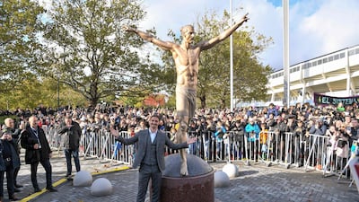 Zlatan Ibrahimovic poses next to the bronze statue of him, at the unveiling ceremony on Tuesday, near the stadium where he made his professional football debut in his hometown of Malmo in southern Sweden. AFP