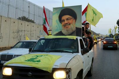 Hezbollah vehicles parade in the streets. Reuters