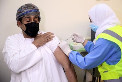 A man receives his first dose of the Pfizer-BioNTech Covid-19 vaccine in the Omani capital, Muscat. AFP