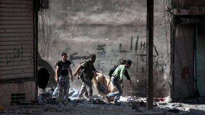 Comrades in arms carry the body of a fellow Free Syrian Army fighter, killed by a tank blast on the front line in Aleppo.