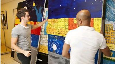 John Cairney, left, the creative manager at Saks Fifth Avenue, and Al Duazo, visual manager, with Khawla Al Marri's artworks for the window display at the shop in Dubai's Burjuman Centre.