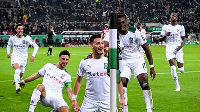 Ramy Bensebaini (C) celebrates with his teammates after scoring the second. EPA