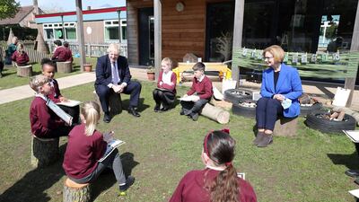 Boris Johnson and Julia Gillard speak to pupils at Cleves Cross Primary School. Reuters
