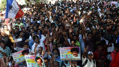 Indian fans of Rajinikanth celebrate after his announcement that he will enter into politics. Arun Sankar / AFP