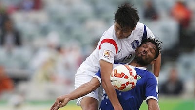South Korea's Kim Young-gwon fights for the ball with Kuwait's Youssef Nasser Al Sulaiman during their Asian Cup match on Tuesday in Canberra. Tim Wimborne / Reuters