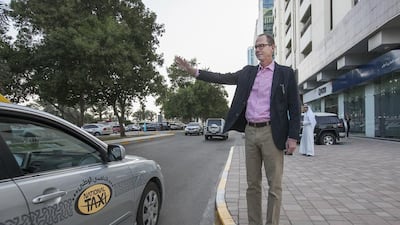 John Winner hails a cab for work in Abu Dhabi. His monthly cost is Dh520. Mona Al Marzooqi / The National