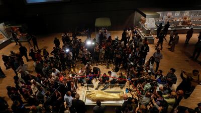 Members of the media are seen around the coffin. Reuters