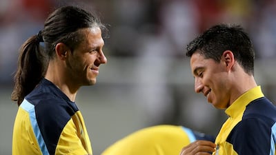 Martin Demichelis, left, talks with Samir Nasri, right, during Manchester City's training session on Wednesday in Abu Dhabi. Satish Kumar / The National / May 14, 2014