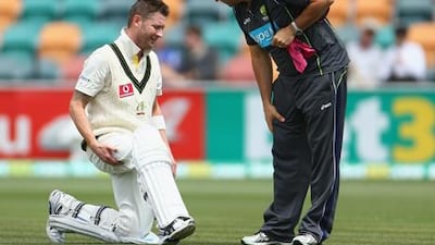 Australia captain Michael Clarke talks to physio Alex Kountouris on the field against Sri Lanka.