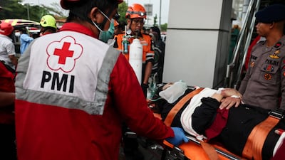 Rescuers cart a survivor out of the train wreck. Reuters