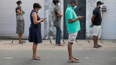 People maintain the one-metre distance in-between each other as they stand in a line to buy groceries at a supermarket in Colombo, Sri Lanka. Reuters