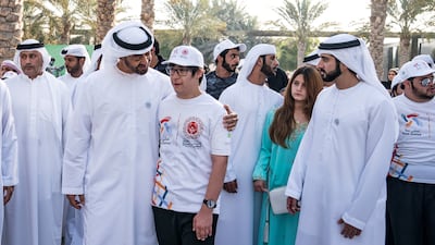UAE swimmer Omar Al Shami with Sheikh Mohamed during a walk in Abu Dhabi, along with Sheikh Hamdan bin Mohamed, Crown Prince of Dubai, and Sheikha Al Jalila bint Mohammed.