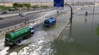 Lorries negotiate a flooded Al Khail road in Dubai.