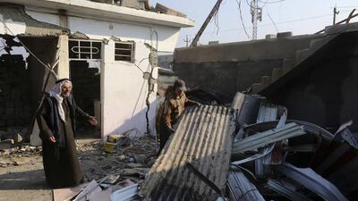 Returning civilians clean their badly damaged house in the eastern side of Mosul, Iraq on January 23, 2017. Hundreds of families are moving back to Mosul after the Iraqi security forces retook much of the city's eastern half from ISIL militants. Khalid Mohammed/AP Photo