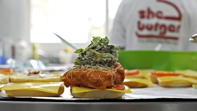 The most popular of the Sheburgers is this buffalo chicken burger, pictured in the kitchen of Sheburger in Mirdif, Dubai. Jeff Topping / For The National