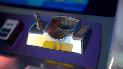 A fruit machine takes one-pound coins. The Royal Mint will begin replacing existing round £1 coins in 2017 in a bid to stamp out fraud. Bethany Clarke / Getty Images