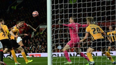 Manchester United's Marcos Rojo heads in the second goal for his side in their 3-0 FA Cup fourth round replay win over Cambridge United on Tuesday. Nigel Roddis / EPA