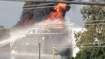 Fire crews spray water at the blaze. Reuters