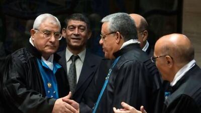 Adly Mansour (left) is congratulated by judges during a ceremony in which he was sworn in as head of the Supreme Constitutional Court, in Cairo.