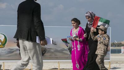 People attend a military display along the Corniche Road in Abu Dhab. Silvia Razgova / The National
